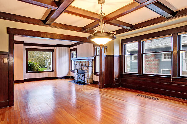 Empty room with wood paneled walls and coffered ceiling.  View of family room with old fireplace with stone trim.  Northwest, USA