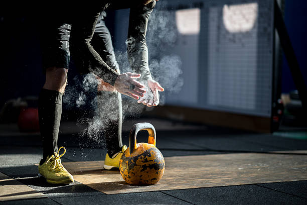 Gym fitness workout: Man ready to exercise with kettle bell Gym fitness workout: Man ready to exercise with kettle bell kettlebell stock pictures, royalty-free photos & images