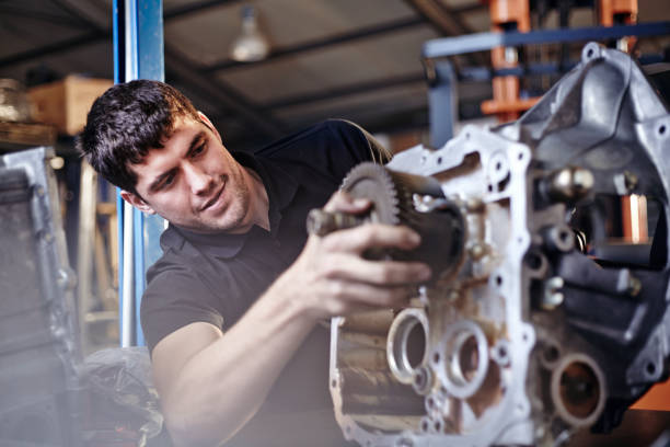istock Mechanic fixing part in auto repair shop 579980619