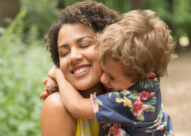 istock Close up affectionate mother and son hugging with eyes closed 579980693