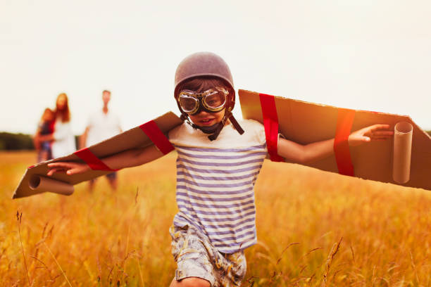 Happy girl spinning around her father in a field. Motion blur.