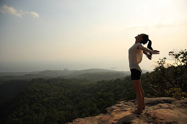 istock young freedom woman open arms on mountain peak 580093662