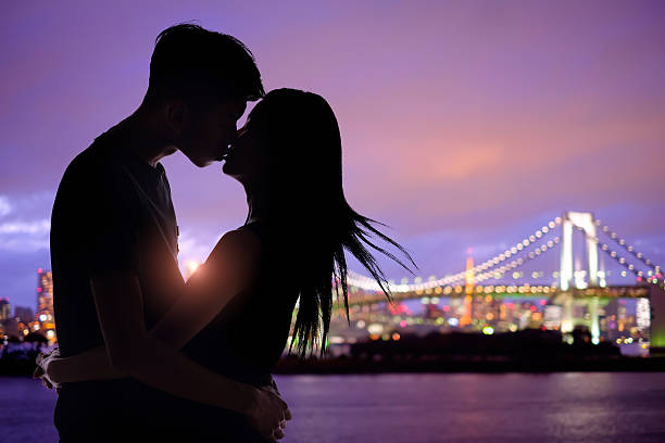 istock silhouette romantic lovers with Odaiba 580093904