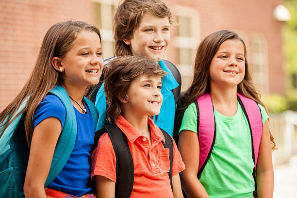 istock Back to School:  Elementary-age children, friends on school campus. 580095388
