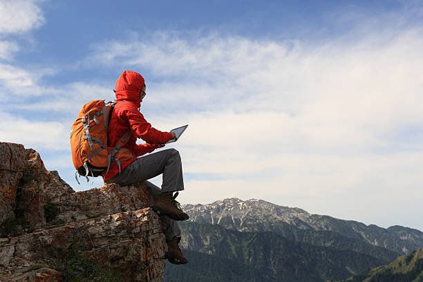 istock woman backpacker use digital tablet taking photo on mountain peak 580095598