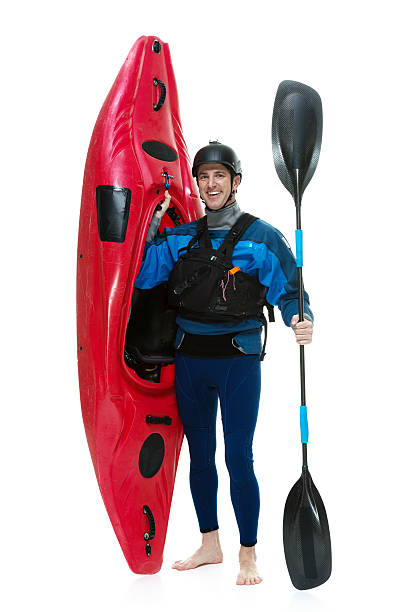 istock Smiling kayaker standing with kayak 580097360