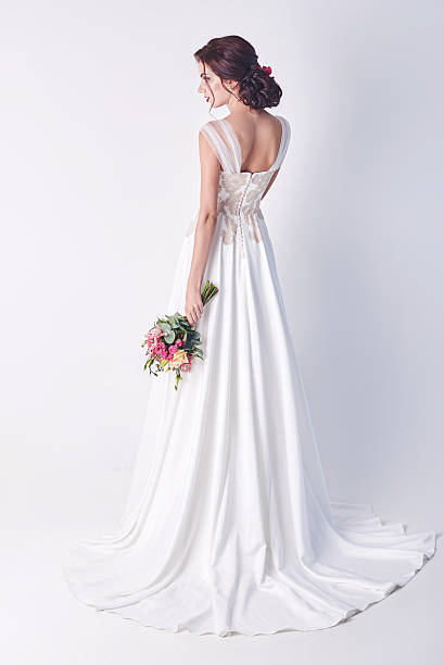 istock Young attractive bride with the bouquet of white roses 580097570