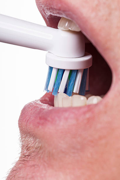 istock Close up of electric toothbrush and paste on white 580098366