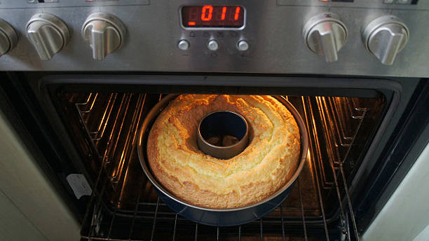 Look in the oven View from above of a Bundt cake in the oven with the door open oven door stock pictures, royalty-free photos & images
