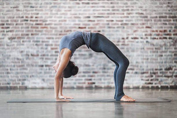 istock Young Woman Doing Yoga Meditation and Stretching Exercises 580101284