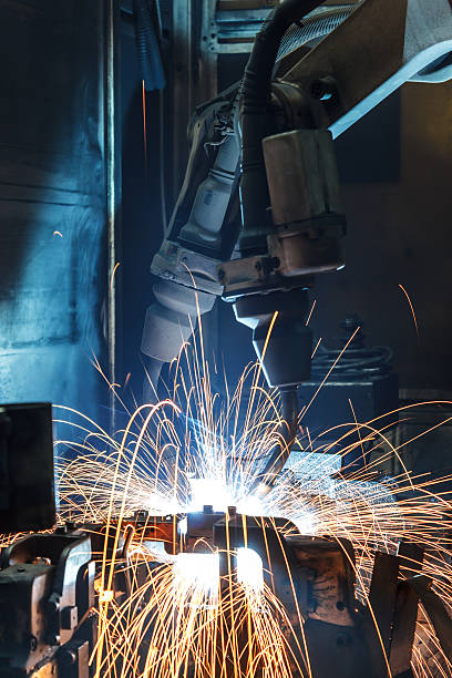 istock robots welding in a car factory 580101612