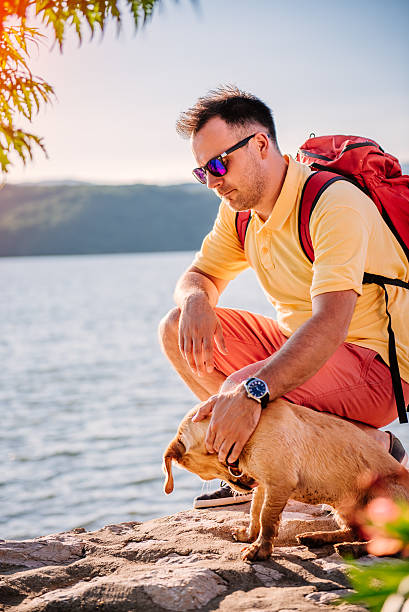 istock Man and dog resting by the sea 580102184