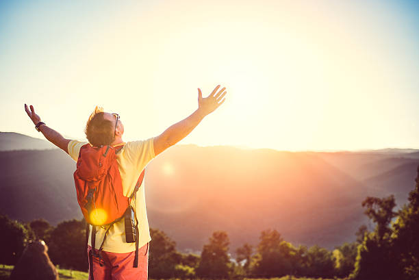 istock Man with arms outstretched on mountain 580102884