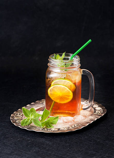 Cold tea with lime and mint in a glass jar