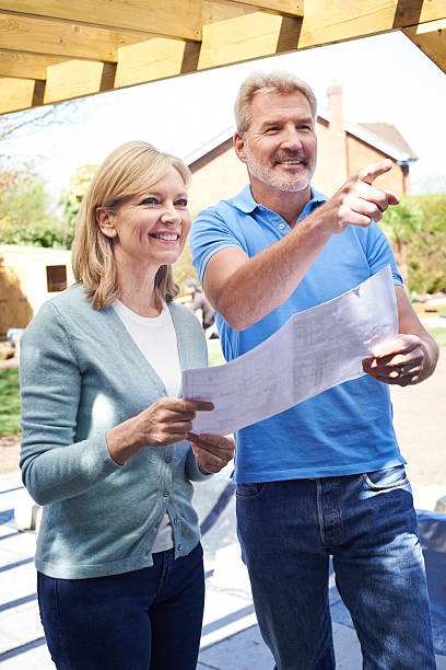 istock Mature Woman Discusses Plan With Landscape Gardener 580105126
