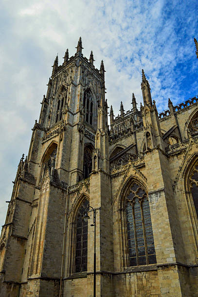 istock Cathedral Tower and Cloudy, Blue Sky, York, England 580105292