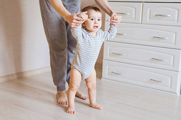 istock First steps of cute baby boy 580106040
