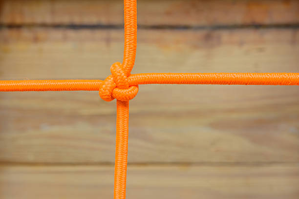 Orange rope tied one point and wood background