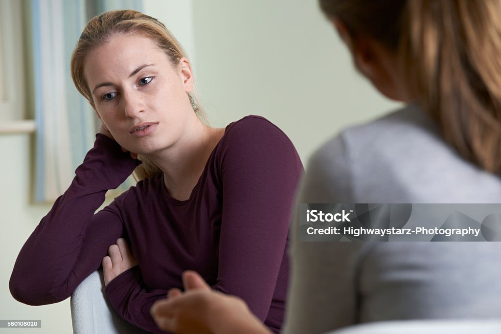 Young Woman Discussing Problems With Counselor Psychotherapy Stock Photo