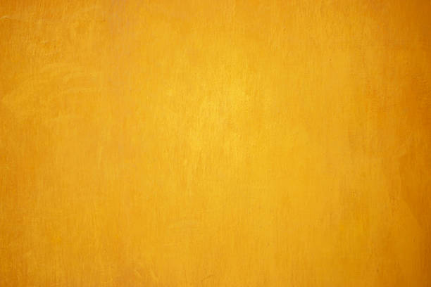 istock Yellow grunge cement wall, textured background. 580108132