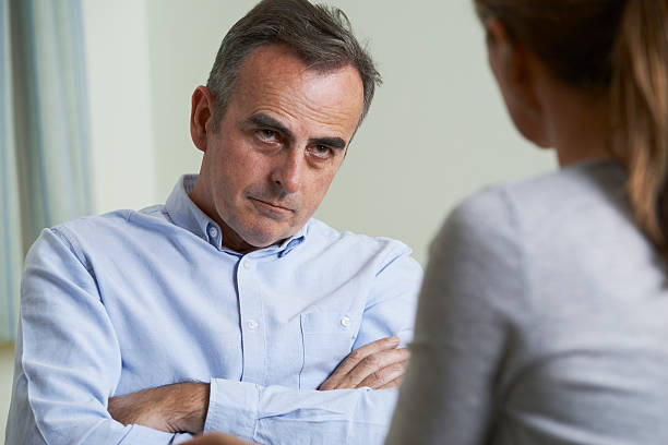 istock Depressed Mature Man Talking To Counsellor 580108180