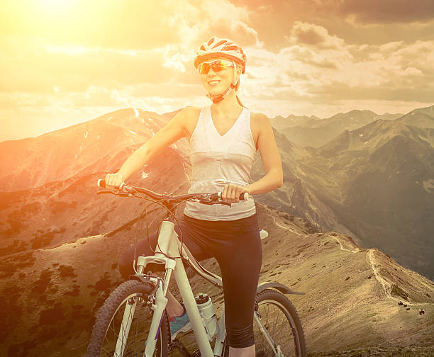 istock Woman stay on the bicycle around mountains 580108774
