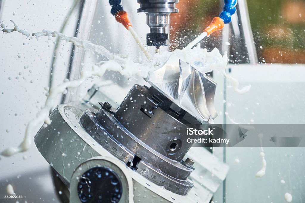 Milling metalworking process. Industrial CNC metal machining by vertical mill Milling metalworking process. Industrial CNC machining of metal detail by cutting end-tooth vertical mill at factory Metal Worker Stock Photo