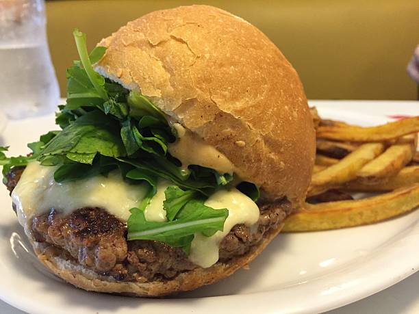 istock delicious burger with cheese, arugula and fries 580109514