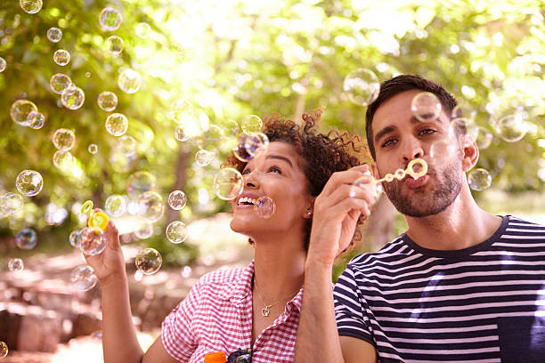 istock Two happy young friends blowing bubbles 580109822