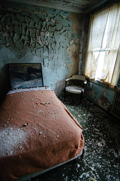 istock Bed and chair in an abandoned hotel 580109938