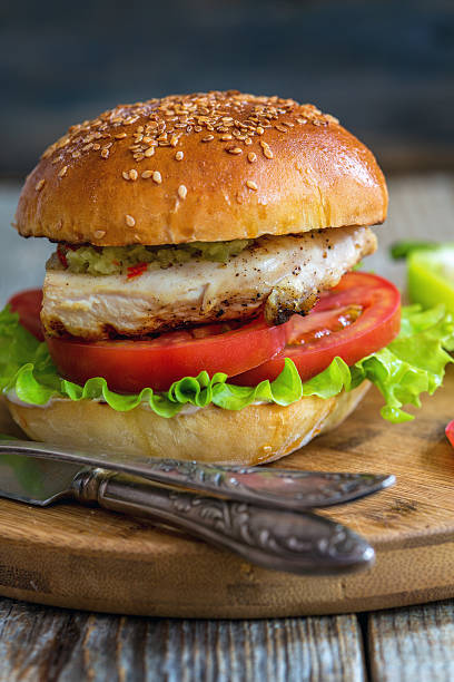 istock Burger with chicken, hot sauce and salad. 580110322