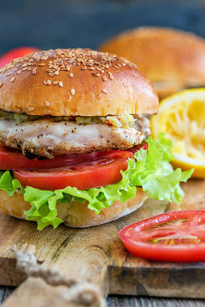 istock Tasty burger with chicken, tomato and spicy sauce. 580110512