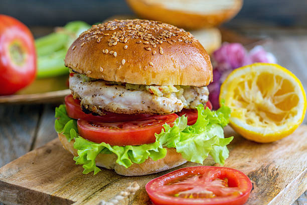 istock Burger with vegetables, chicken and spicy sauce. 580110614