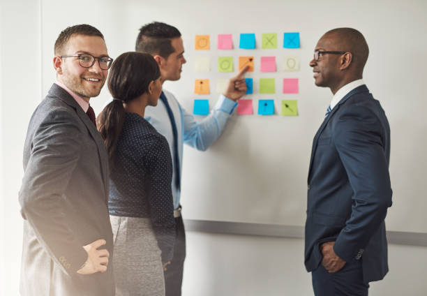 istock Group of businesspeople solving a puzzle 580112616