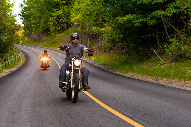 istock Two friends riding motorcycles on country road 580113046