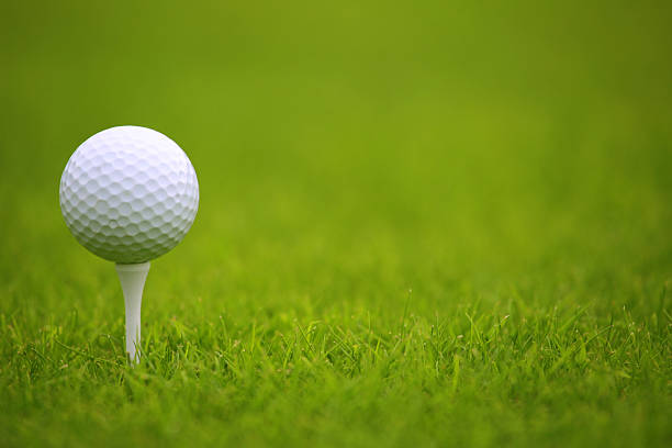 Golf ball on tee White Golf ball on tee on green grass of golf course golf course photos stock pictures, royalty-free photos & images