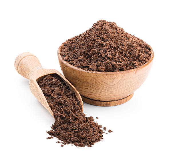 istock Cocoa powder in a wooden bowl isolated on white 580114112
