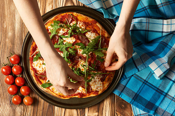 istock Home made pizza on wooden table 580114730