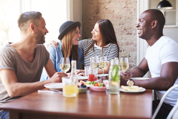 istock Woman hugging friend at dinner table 580115956