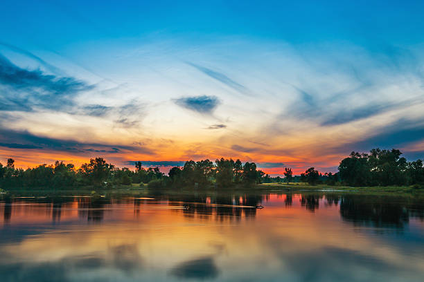 istock Beautiful sunset above a big river 580116290
