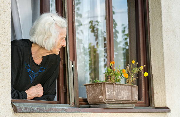 A Senior Citizen Looks On from the Balcony
