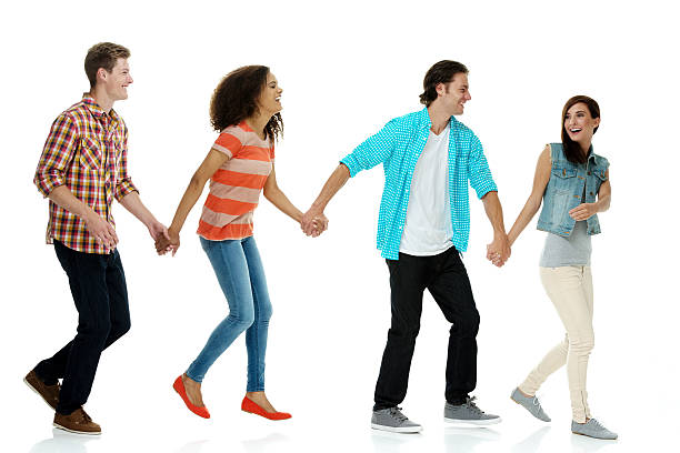 istock Happy friends holding hands and walking 580116680