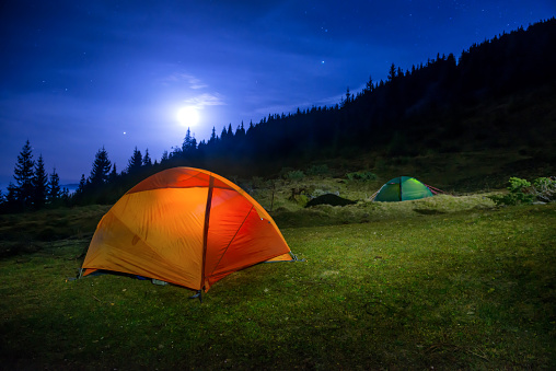 Two Illuminated orange and green camping tents