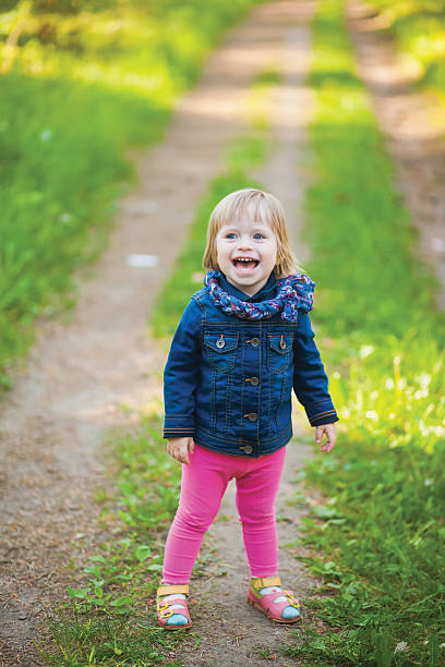istock Toddler laughing girl in forest 580117354