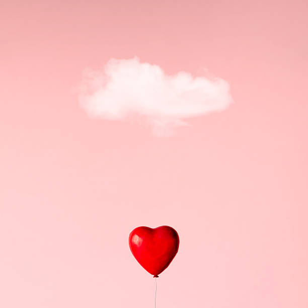 istock Ballon in heart shape on pink sky. Love concept. 580118678