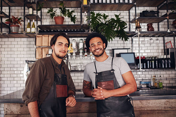 istock Two young coffee shop owners at the counter 580120120