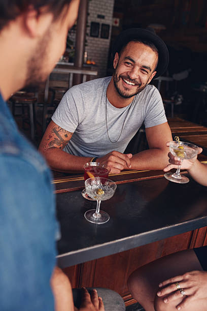 istock Young friends sitting at a cafe table having drinks 580120174