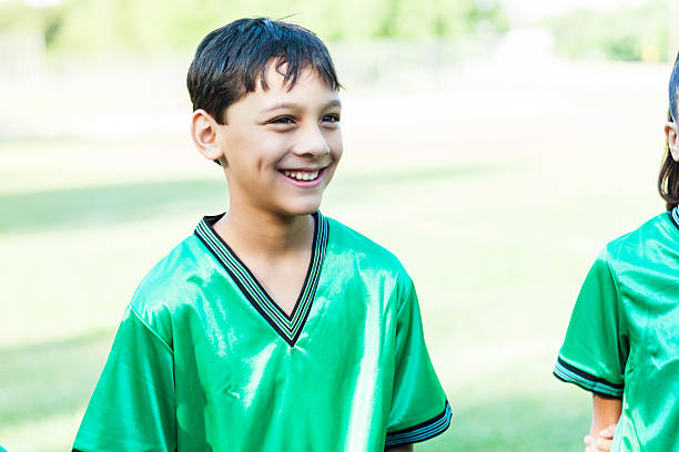 istock Handsome preteen soccer player in green uniform 580121078
