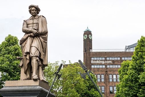 Amsterdam, Netherlands - June 29, 2016: Rembrandt monument in front of booking.com headquaters in famous Rembrandt park in Amsterdam, Netherlands.