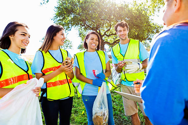istock Diverse group of people prepare to clean up community 580121598